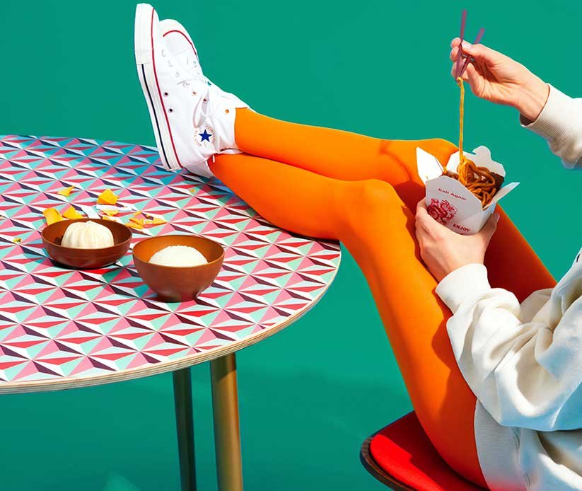 Woman Eating with Feet up on the Table Woman Eating with Feet up on the Table